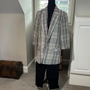Women’s black and tan Plaid Blazer with black leggings.